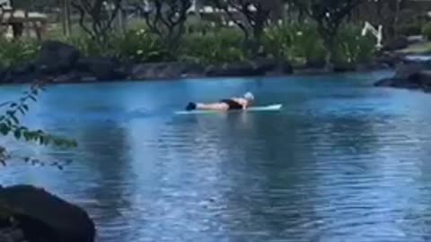 Big swell coming through guy surfs onto lake