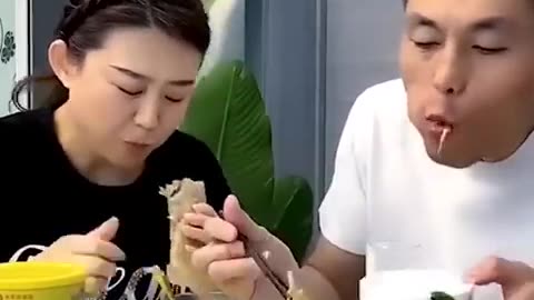 Funny eating food by husband and wife