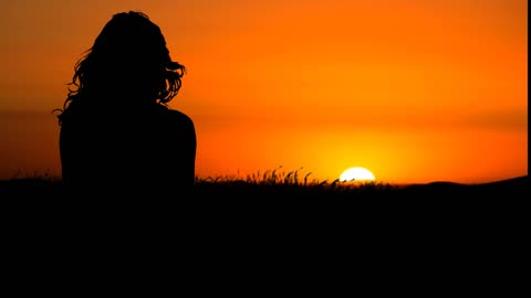 Woman admiring the wonderful sunset - nature.