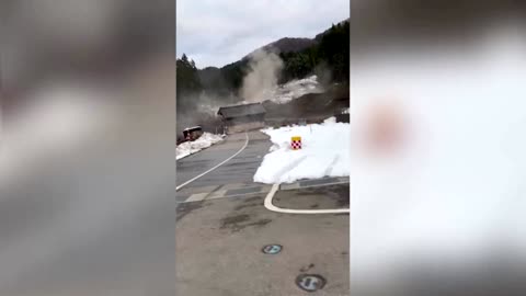 Residents escape a landslide following Japan quake