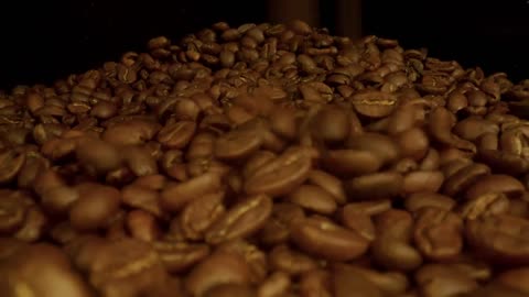 Many coffee beans on a black background