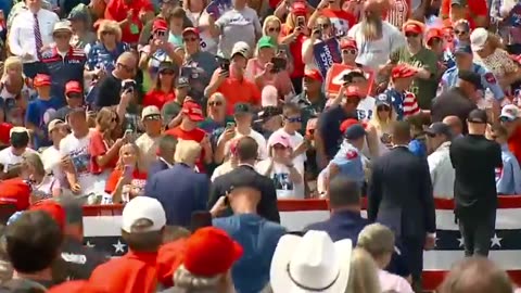 FEARLESS: Trump leaves bulletproof glass to check on a supporter who passed out.