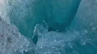 Water flowing into mysterious caverns beneath a massive glacier in Alaska