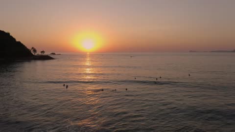 Sunset in the open sea from the top of a beach