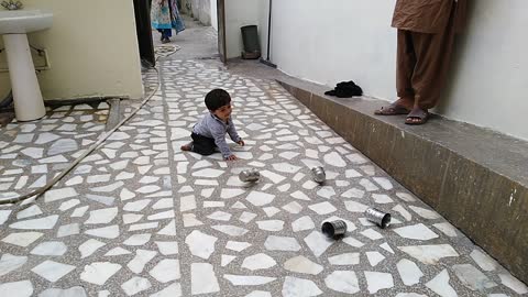 Four glasses are dancing in front of cute baby to make him happy