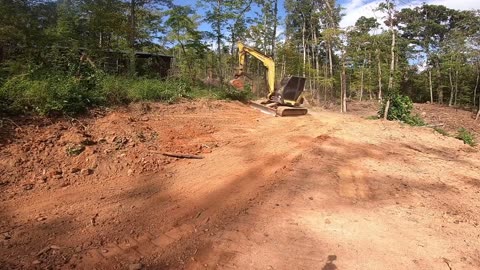 Cutting roadside bank with excavator