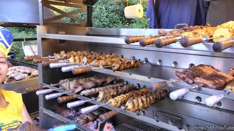 Brazil Street Food. Roasting Huge Churrasco and Meat on Grill