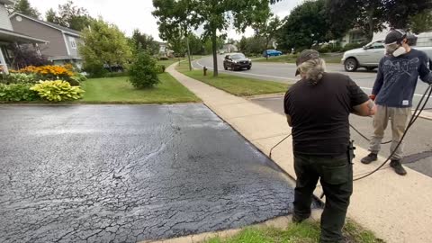 Professional Asphalt Spray Sealing: “The Slopy One” Top Coats Pavement Maintenance