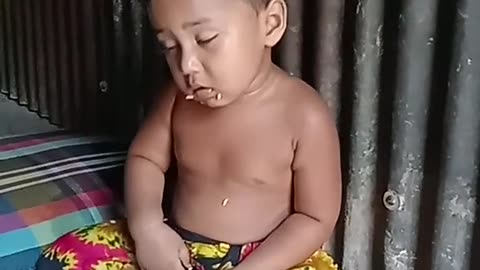 A small child is very sleepy after sitting down to eat--