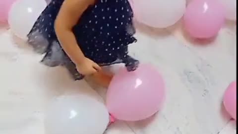 cute baby playing with the balloon