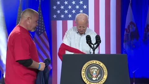 JOE SPEAKS TO UAW: President Biden Needs Help Putting on Shirt