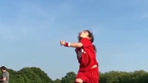 A small little girl back flip Soccer kick