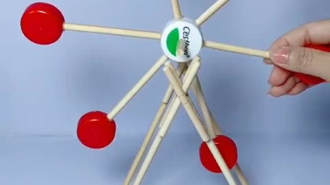 With disposable chopsticks, and the accumulation of bottle caps to create a Ferris wheel