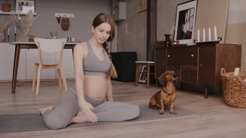 Dachshund giving company to his Pregnant owner during Yoga