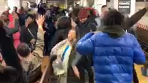 People sing and dance to mo bamba together in subway station