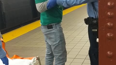 Drunk guy in green st paddys outfit on subway platform