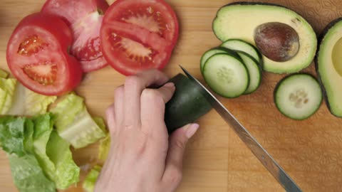 Top view of a woman slicing vegetables