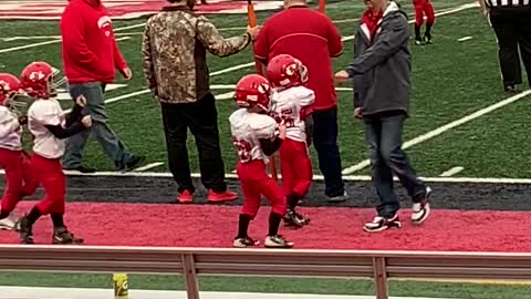 Peewee Football Player Grooves Away on the Sidelines