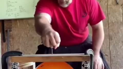 Strongman Pops Balloon Under Wooden Board By Driving Nail Through It With His Hand