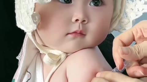 a so cute baby is crying while injection