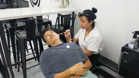 Professional relaxing earwax removal service, girl with top skills