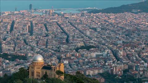 panorama of barcelona time lapse with palace on hill from mount tibidabo before sunset