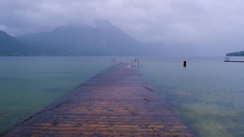 Serene Lake Promenade in the Rain: Embrace the Raindrops ☔🌊