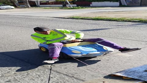 Garbage Man Rides Along on Toy Car