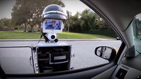 Watch a "Police Robot" Pull a car over.