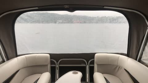 Pontoon boat in a downfall