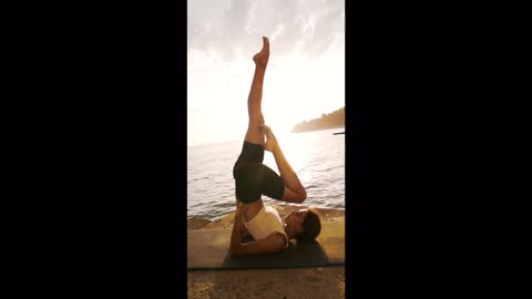 Astonishing yoga exercise by the ocean