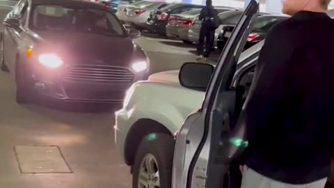 Woman goes against one way traffic in a parking garage, yells at a guy