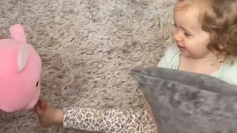 Adorable little girl plays peek-a-boo with pig!