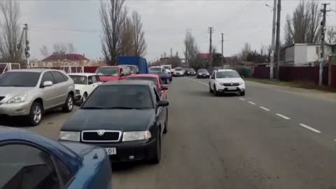 Ukraine_ People sit in traffic jams to flee as smoke rises from ammunition depot