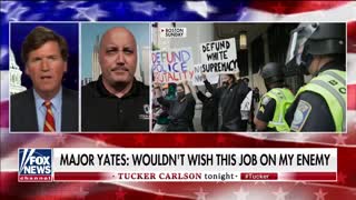 Travis Yates speaking with Tucker Carlson