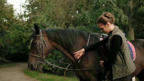 Closeup view of unrecognizable professional horse rider dismounting from the horse