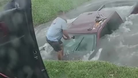 Texas couple rescues driver in submerged truck from flooded ditch