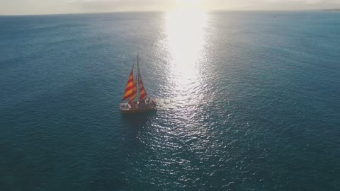 a sailboat traversing the deep sea