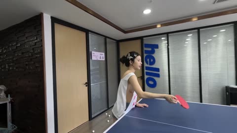 Sexy asia girl wearing sports vest playing table tennis