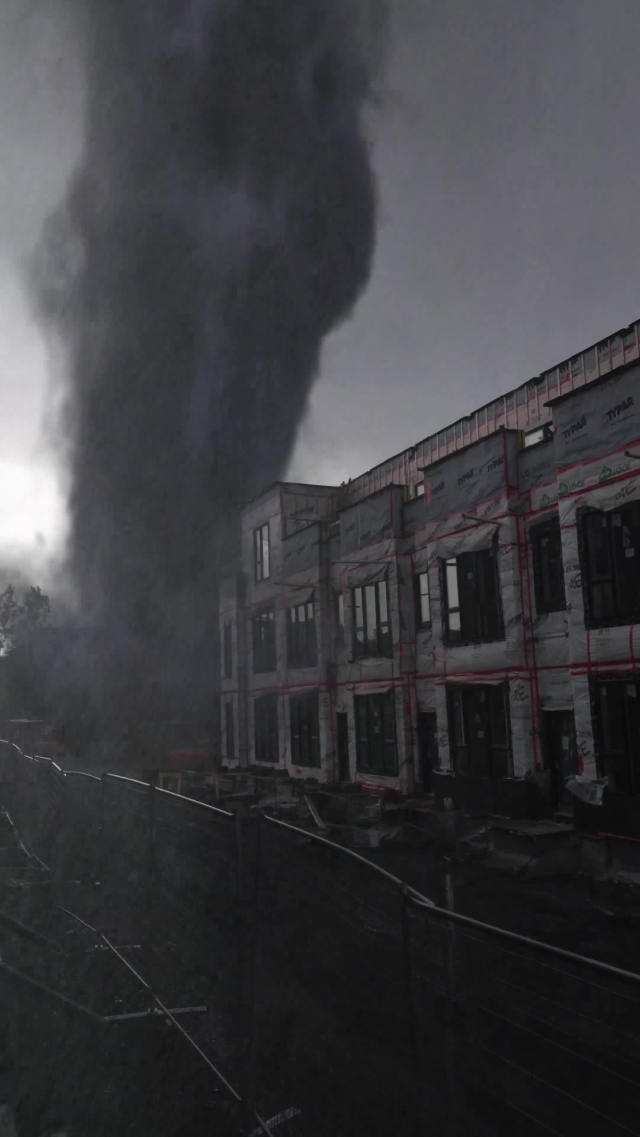 Tornado caught on camera close to the building, fake or real