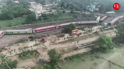 Drone footage shows stretch of derailed train carriages, crowds at India crash site