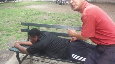 Luodong Massages Black Man In Adidas Pants On The Park Bench