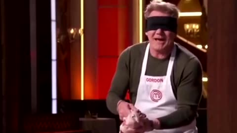 Gordon Ramsey cuts a chicken in pieces while blindfolded