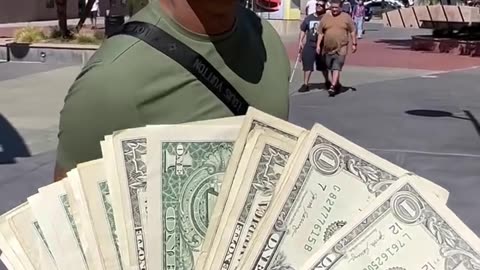 Giving away cash to strangers and only one person took all cash.hd