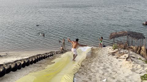 Man Surfs Down Waterslide and Somersaults Into Water