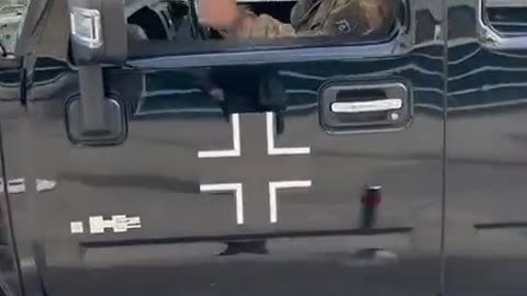 Ukrainian military official on the Hummer and the Iron Cross of Nazi Germany.