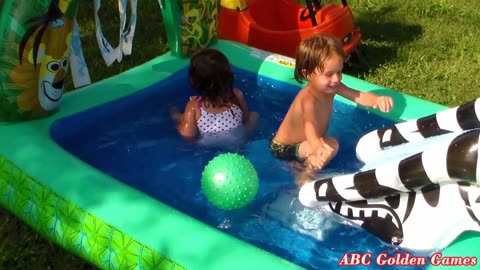 Kids Swim in Inflatable Jungle Swimming Pool Having Fun