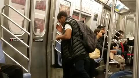 Man wearing black vest pretending to box