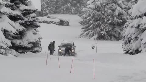 Family Strains Getting Car From Snowbank