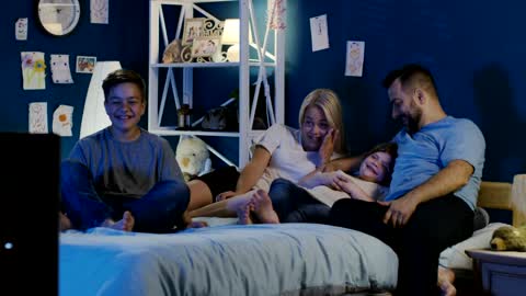 Happy family gathers watching TV